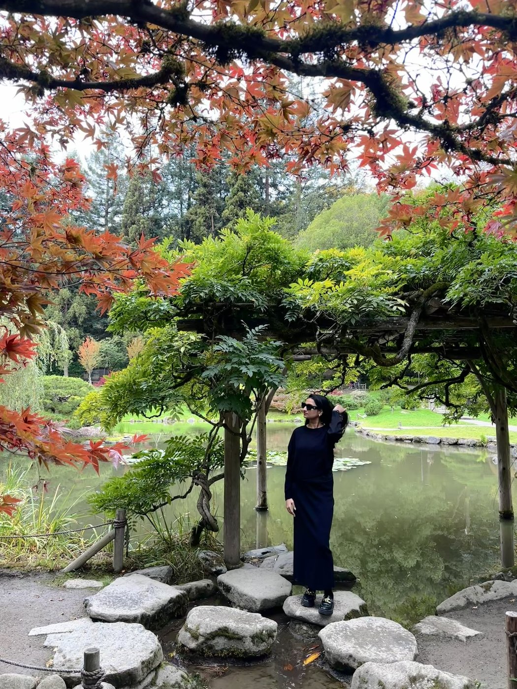 Trisha among Japanese maple trees and a koi pond