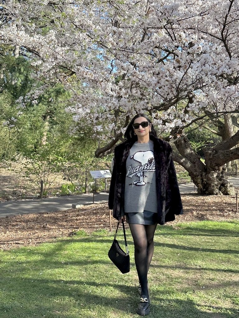 Trisha walking under cherry blossoms in spring